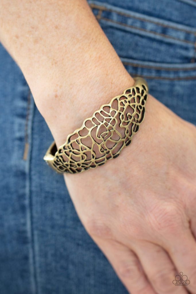 Glistening brass bars coalesce into an airy stenciled cuff-like bracelet around the wrist for a whimsical metallic look. Features a hinged closure.  Sold as one individual bracelet.