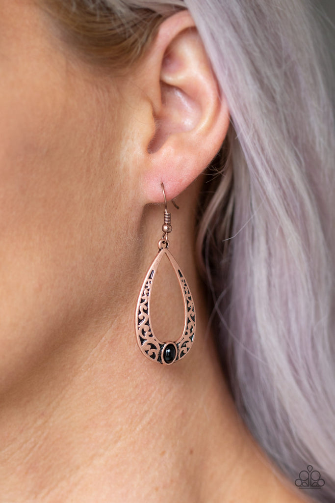 A shiny black bead is pressed into the bottom of a teardrop frame embossed in copper vine-like filigree for a whimsical look. Earring attaches to a standard fishhook fitting.  Sold as one pair of earrings.