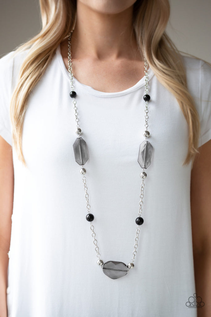 A collection of polished black beads, shiny silver beads, and oversized faceted crystal-like beads trickle along a shimmery silver chain across the chest for a whimsically refined look. Features an adjustable clasp closure.  Sold as one individual necklace. Includes one pair of matching earrings.  