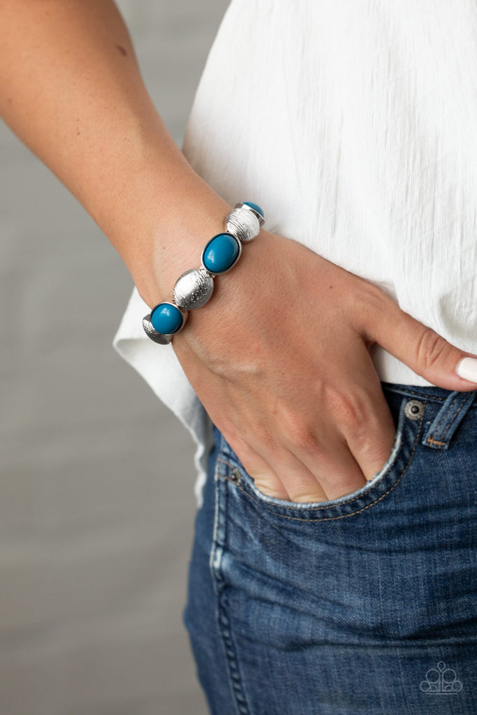 Bubbly blue beaded frames and textured silver caps alternate along stretchy bands around the wrist, adding a colorful pop of color.  Sold as one individual bracelet.