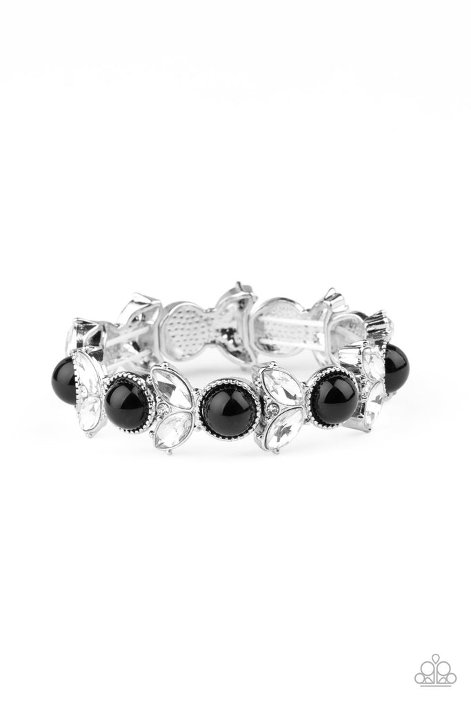 Encrusted in dazzling white rhinestones and an oversized black bead, leafy silver frames are threaded along stretchy bands around the wrist for a timeless look.  Sold as one individual bracelet.