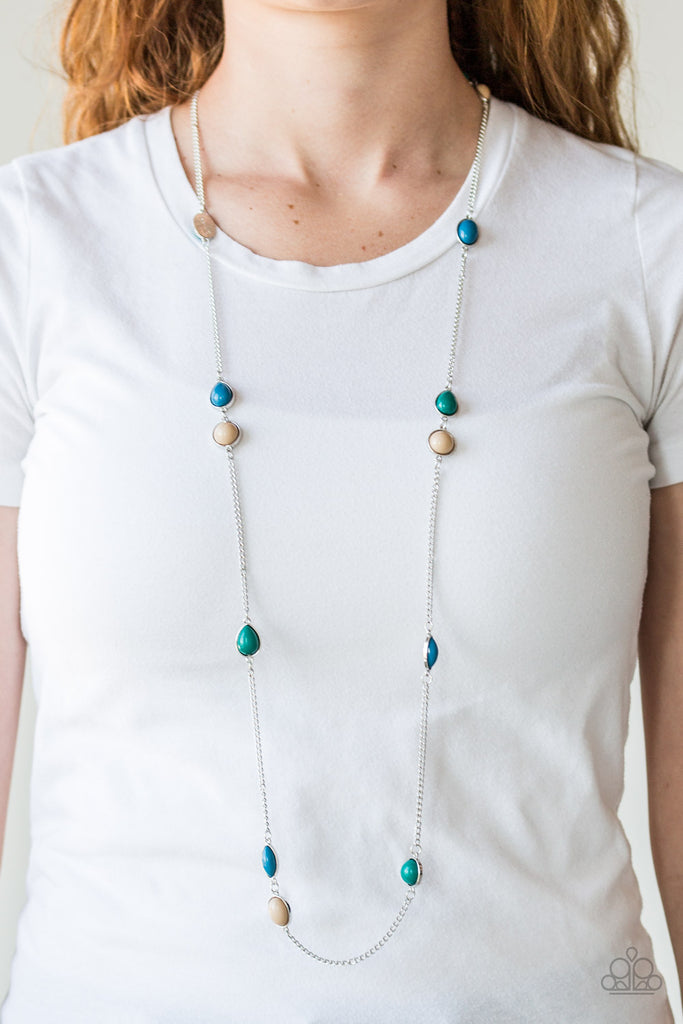 Featuring round and teardrop shapes, blue, brown, and green beads trickle along an elongated silver chain for a seasonal look. Features an adjustable clasp closure.  Sold as one individual necklace. Includes one pair of matching earrings.