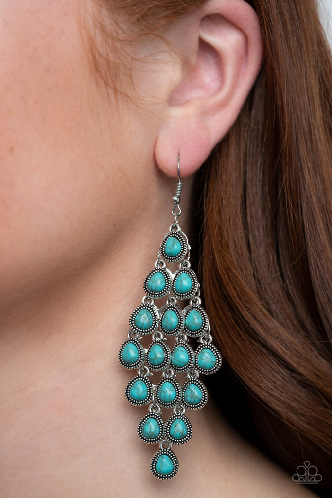 Featuring studded silver frames, dainty turquoise teardrops cascade from the ear. The earthy frames dangle from a netted backdrop, coalescing into a rustic lure. Earring attaches to a standard fishhook fitting.  Sold as one pair of earrings.
