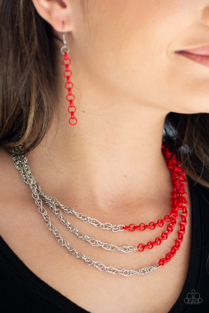 Rows of shimmery silver chains merge with shiny red chains, creating colorful layers below the collar. Features an adjustable clasp closure.  Sold as one individual necklace. Includes one pair of matching earrings.
