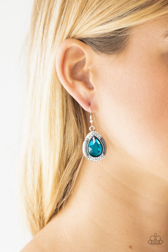 A faceted blue teardrop gem is pressed into a shimmery silver frame radiating with studded details and glassy white rhinestones for a magnificent look. Earring attaches to a standard fishhook fitting.  Sold as one pair of earrings. 