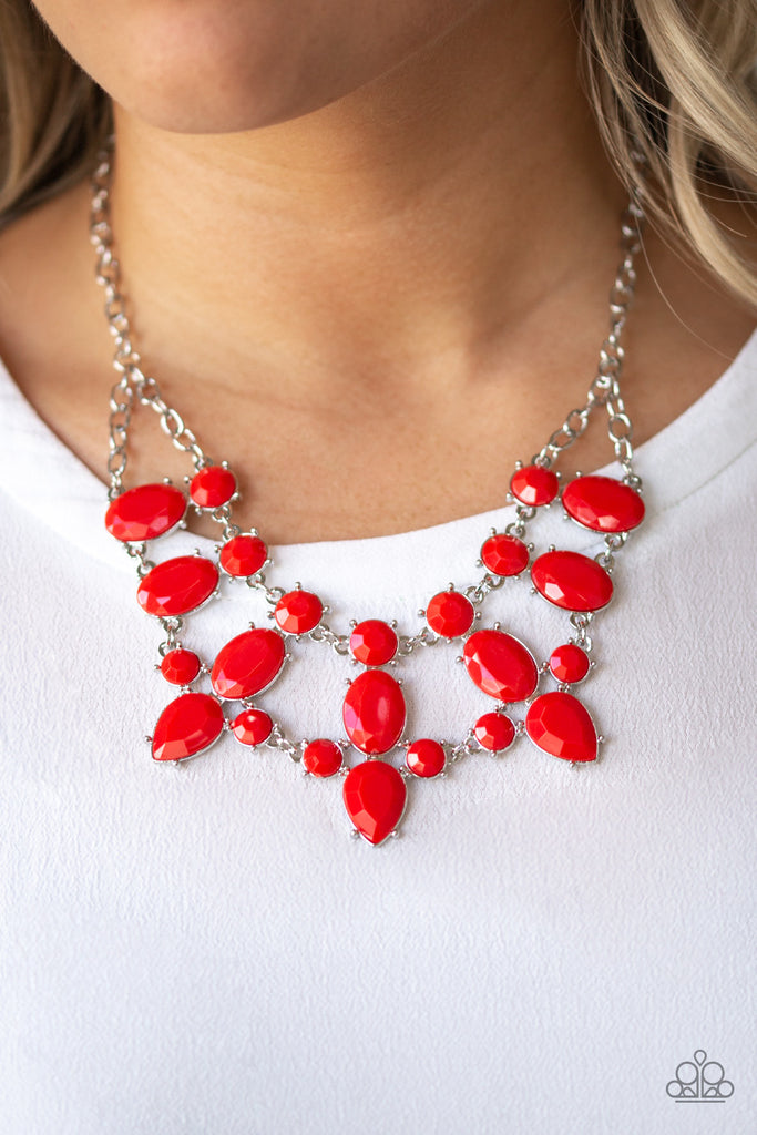 A collision of round, oval, and teardrop red beaded frames delicately connect below the collar for a glamorous look. Features an adjustable clasp closure.  Sold as one individual necklace. Includes one pair of matching earrings.