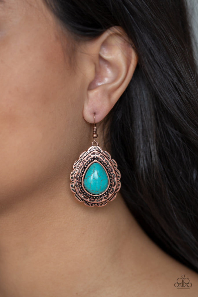 Chiseled into a tranquil teardrop, a refreshing turquoise stone is pressed into a scalloped copper frame radiating with tribal inspired patterns for a seasonal look. Earring attaches to a standard fishhook fitting.  Sold as one pair of earrings.