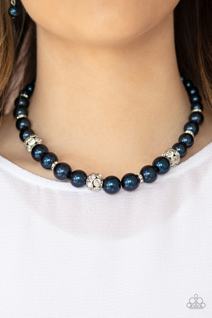 Infused with dainty white rhinestone encrusted rings, a collection of navy blue pearls and sparkling white rhinestone encrusted beads are threaded along an invisible wire below the collar for a refined fashion. Features an adjustable clasp closure.  Sold as one individual necklace. Includes one pair of matching earrings.