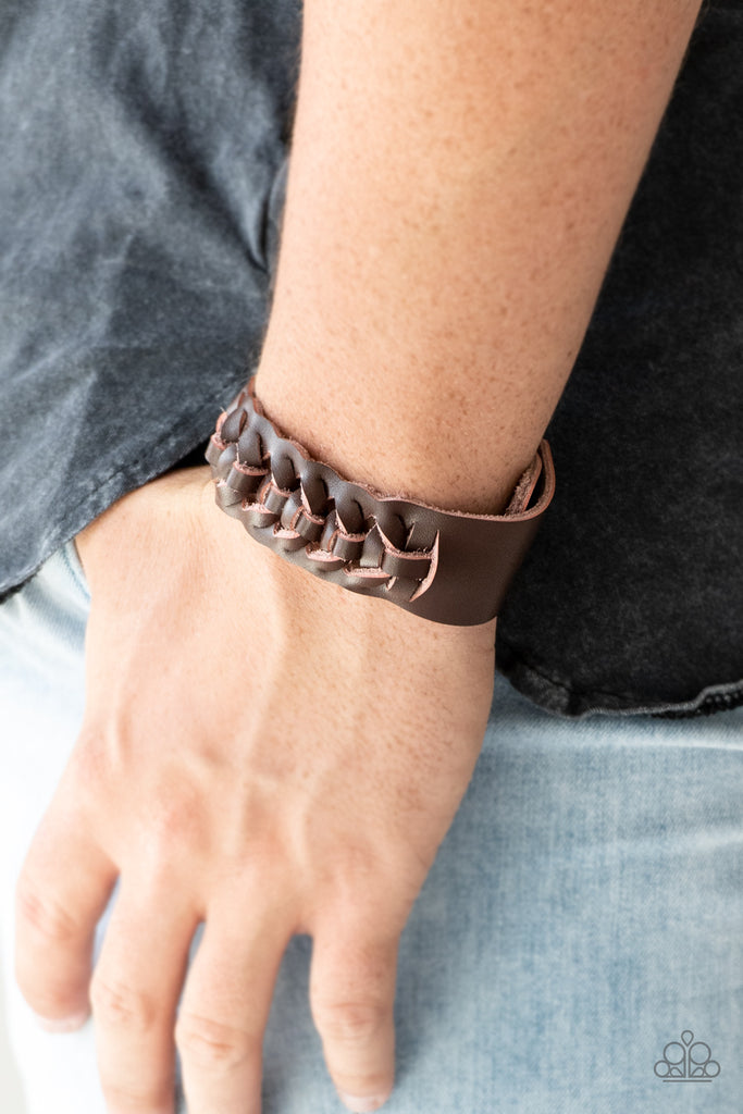 The center of a brown leather band weaves into a rugged braid across the wrist for a rustic look. Features an adjustable snap closure.  Sold as one individual bracelet.