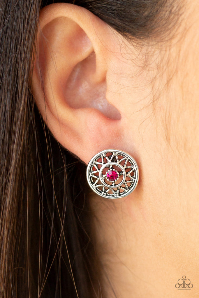 A dainty pink rhinestone dots the center of a shiny silver frame radiating with a glistening sunburst pattern for a whimsical look. Earring attaches to a standard post fitting.  Sold as one pair of post earrings.