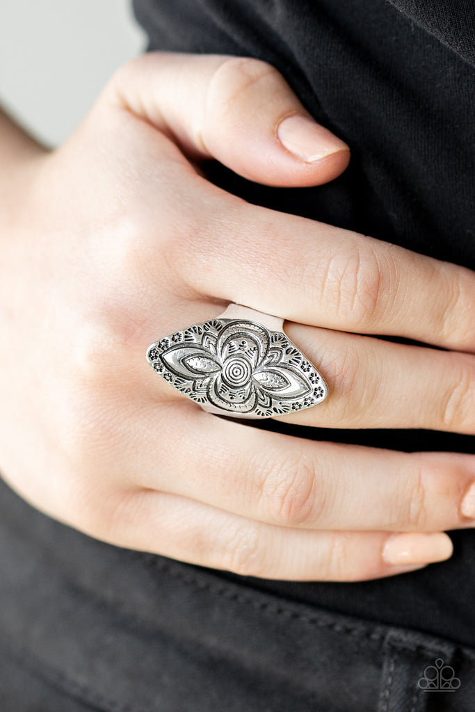 Stamped in floral patterns, a shimmery silver frame folds around the finger for a seasonal flair. Features a stretchy band for a flexible fit.  Sold as one individual ring.