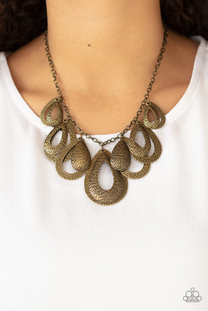 Hammered in an antiqued textured finish, pairs of mismatched brass teardrops gradually increase in size as they drip below the collar, creating a statement-making fringe. Features an adjustable clasp closure.  Sold as one individual necklace. Includes one pair of matching earrings.