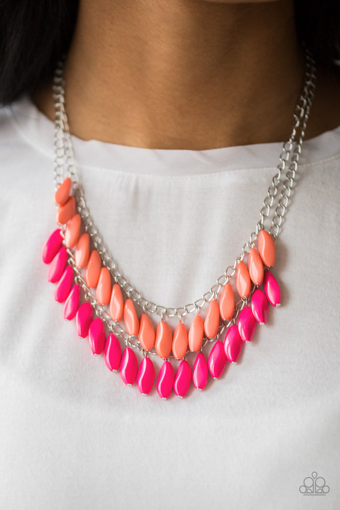 A row of faceted Living Coral beads swings above a row of faceted pink beads, creating a vivacious double fringe below the collar. Features an adjustable clasp closure.  Sold as one individual necklace. Includes one pair of matching earrings.