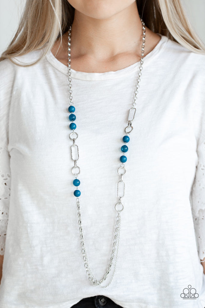 A collection of glassy and polished blue beads give way to layers of mismatched silver chain for a whimsical look. Features an adjustable clasp closure.  Sold as one individual necklace. Includes one pair of matching earrings.