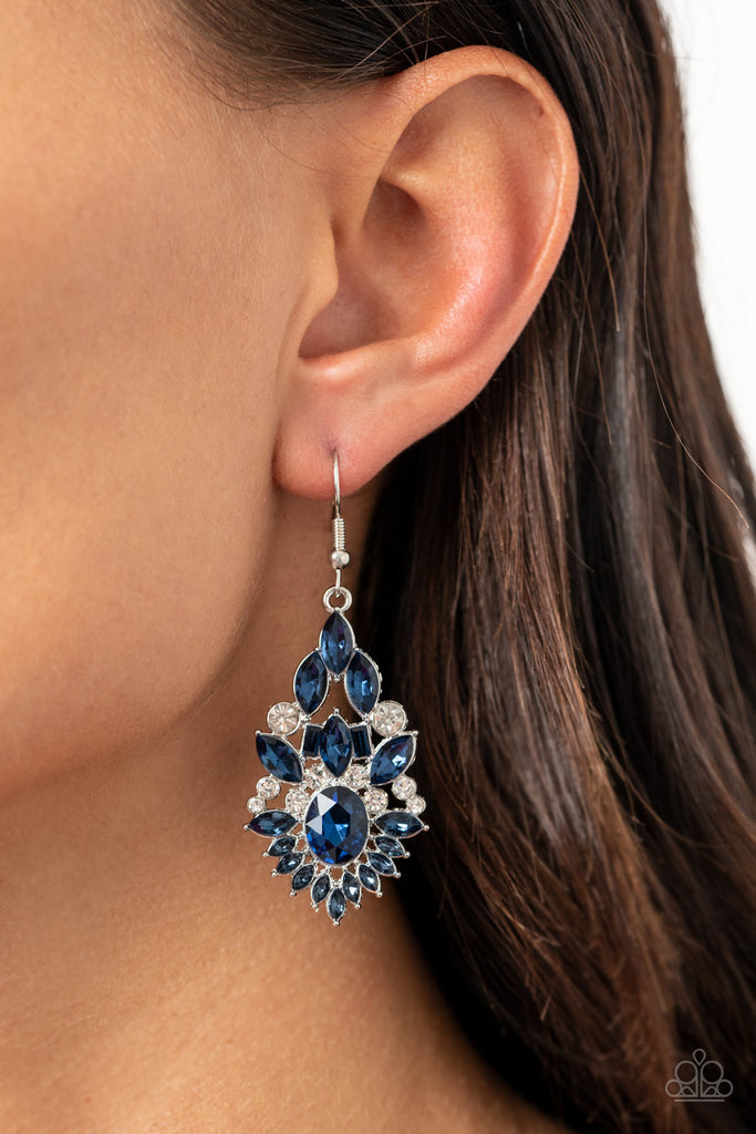 Featuring an elegant variety of round, marquise, oval, and emerald style cuts, a glittery collision of blue and white rhinestones delicately coalesce into a jaw-dropping lure. Earring attaches to a standard fishhook fitting.  Sold as one pair of earrings.