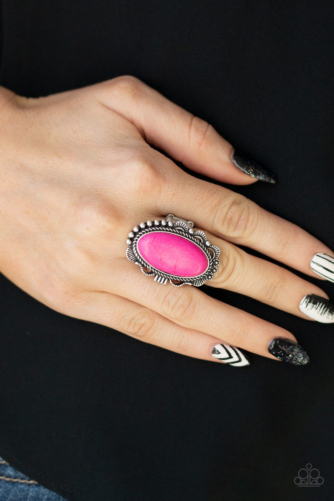 A vivacious pink stone is pressed into an ornate silver frame rippling with studded and serrated textures for a seasonal flair. Features a stretchy band for a flexible fit.  Sold as one individual ring.