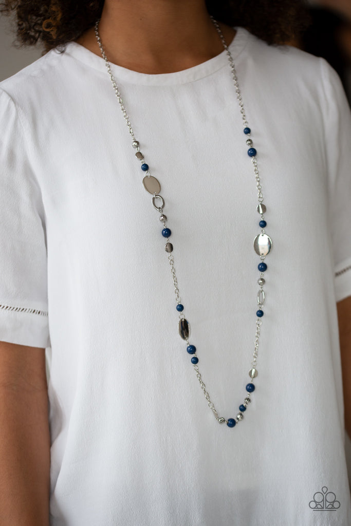 An array of polished blue beads, silver discs, and ornate silver accents trickles along a shimmery silver chain for a whimsical look. Features an adjustable clasp closure.  Sold as one individual necklace. Includes one pair of matching earrings.