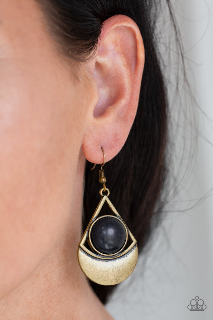 Brushed in an antiqued finish, a glistening triangular frame attaches to a shimmery brass crescent frame. A round black stone is pressed into the center of the geometric frame for a seasonal flair. Earring attaches to a standard fishhook fitting.  Sold as one pair of earrings.