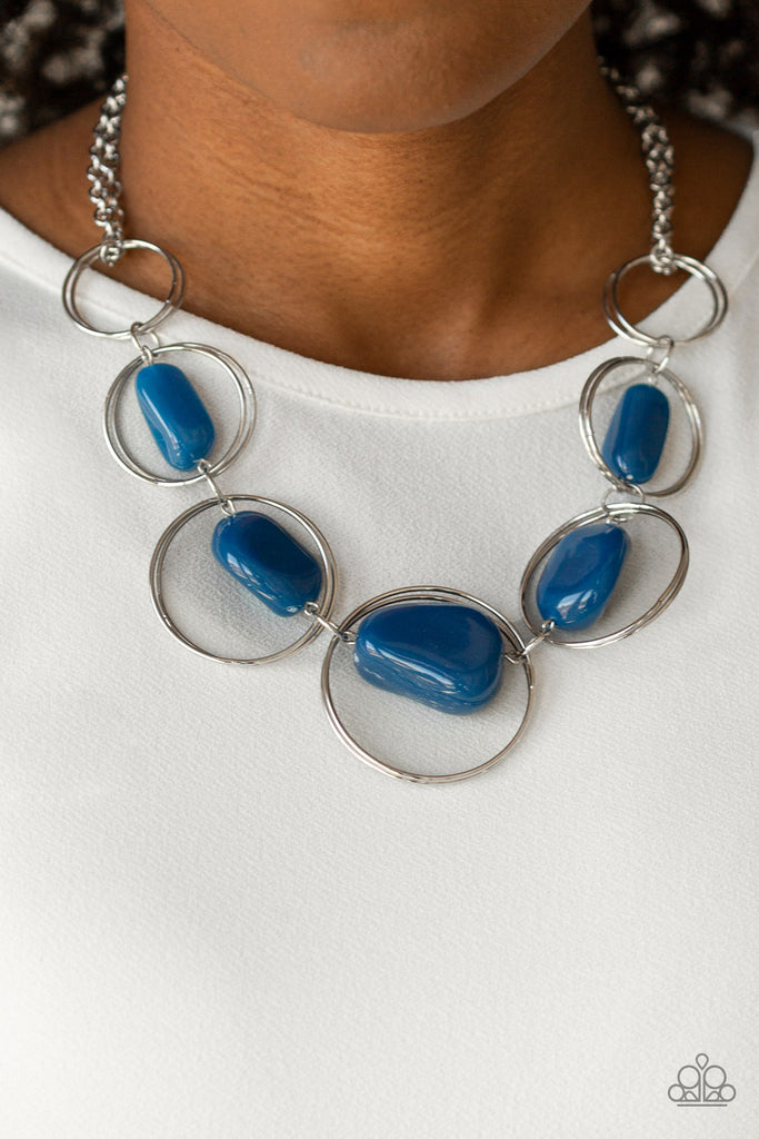 Featuring faux Galaxy Blue rock beads, exaggerated silver hoops gradually increase in size as they link below the collar for a trendy look. Features an adjustable clasp closure.  Sold as one individual necklace. Includes one pair of matching earrings.