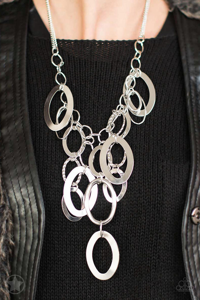 Large silver links and shimmering textured silver rings cascade below a silver chain freely, allowing for movement that makes a bold statement. Features an adjustable clasp closure.  Sold as one individual necklace. Includes one pair of matching earring.