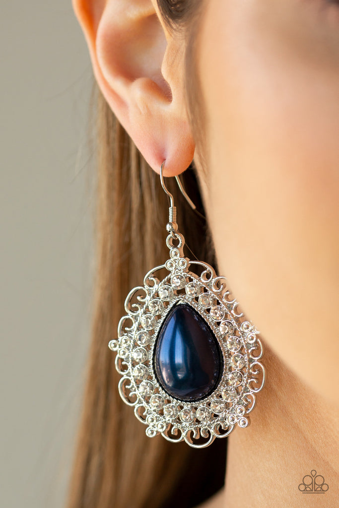 An oversized pearly blue teardrop bead is pressed into a swirling silver backdrop encrusted in a dazzling ring of glassy white rhinestones for a glamorous finish. Earring attaches to a standard fishhook fitting.  Sold as one pair of earrings.