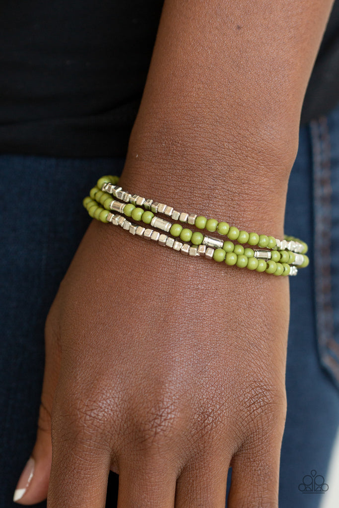 A dainty collection of Guacamole beads, shimmery silver cubes, and glistening silver accents are threaded along stretchy bands around the wrist, creating colorful layers.  Featured inside The Preview at ONE Life! Sold as one set of three bracelets.