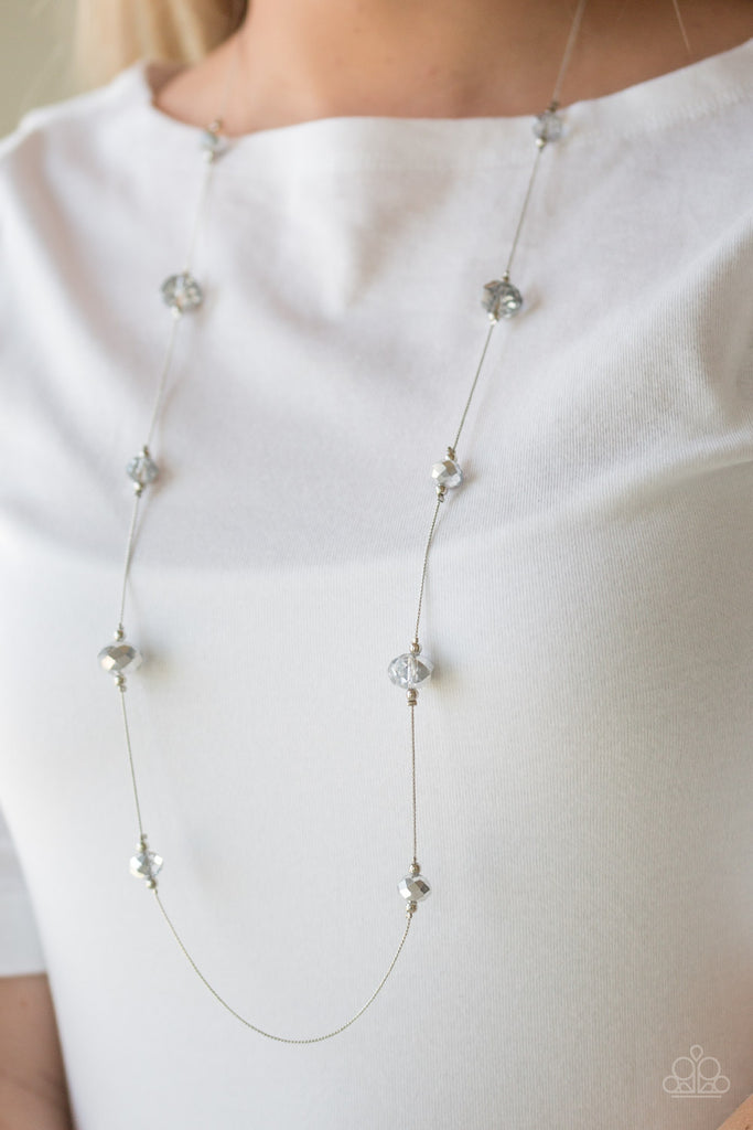 Infused with dainty silver accents, iridescent crystal-like beads trickle along a dainty silver chain across the chest for a refined look. A lobster clasp hangs from the bottom of the design to allow a name badge or other item to be attached. Features an adjustable clasp closure.  Sold as an individual necklace with coordinating earrings. 