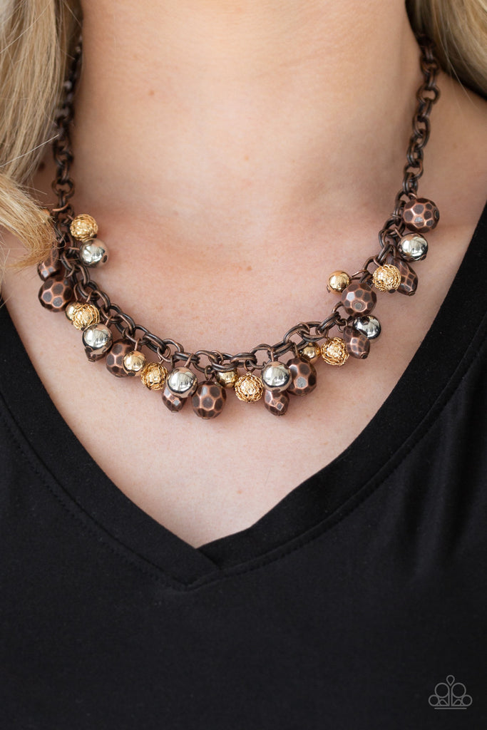 Featuring shiny, faceted, and mesh finishes, mismatched copper, gold, and silver beads trickle below the collar for an edgy industrial look. Features an adjustable clasp closure.  Sold as one individual necklace. Includes one pair of matching earrings.