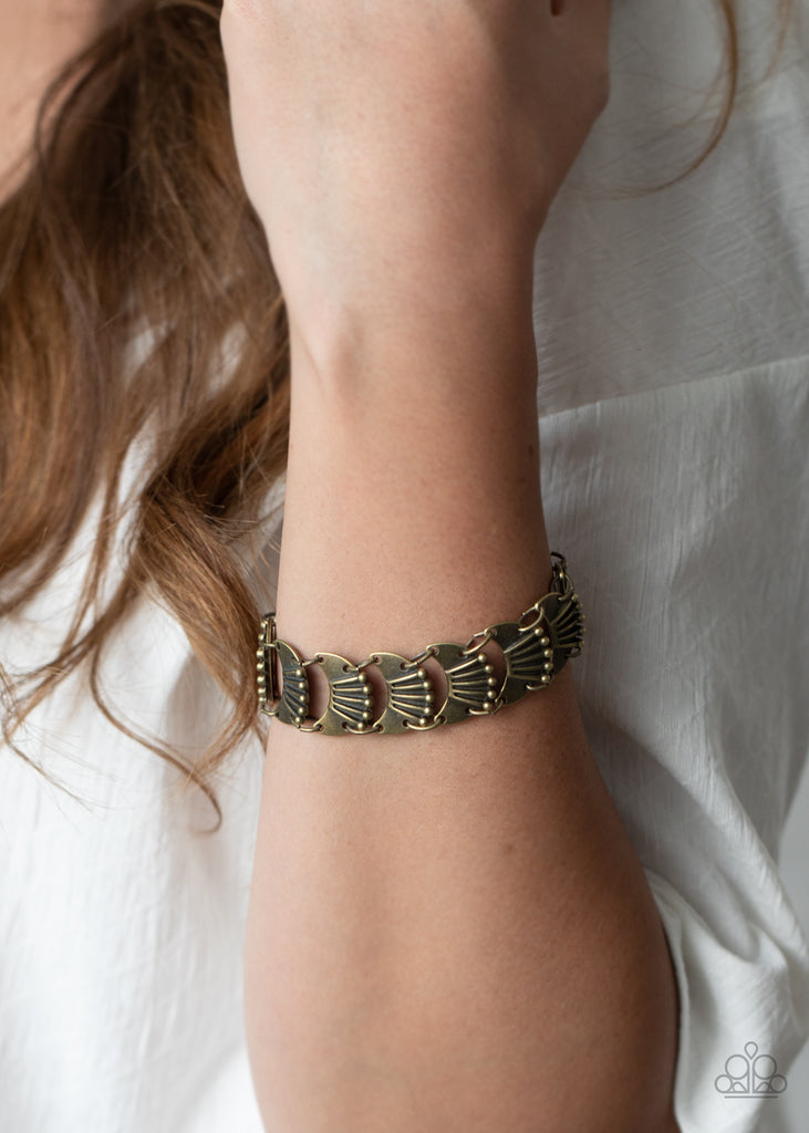 Featuring rustically studded and linear textures, brass crescent frames delicately link around the wrist for an artisan inspired look. Features an adjustable clasp closure.  Sold as one individual bracelet.