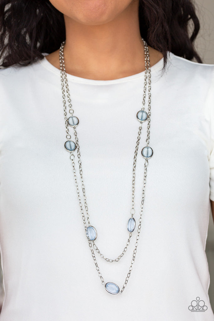Glassy blue beads are threaded along metallic rods, allowing them to spin inside their silver fittings. The colorful frames trickle along two shimmery chains across the chest for a refined layered look. Features an adjustable clasp closure.  Sold as one individual necklace. Includes one pair of matching earrings.