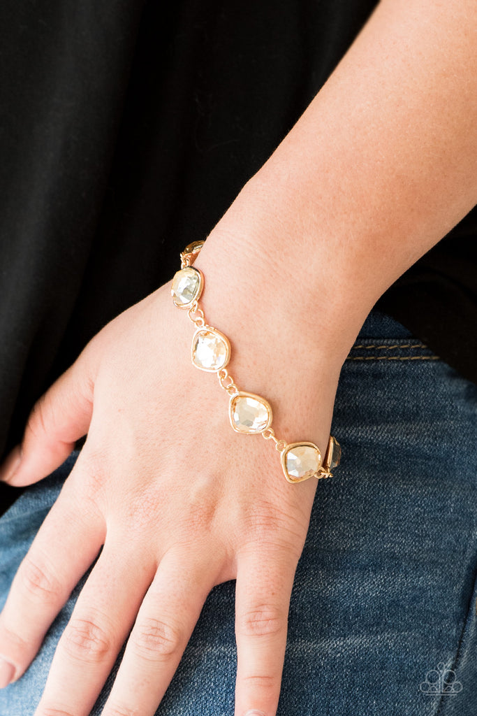 Featuring shimmery gold frames, imperfect golden gems link around the wrist for a glamorous vintage inspired look. Features an adjustable clasp closure. Sold as one individual bracelet.  
