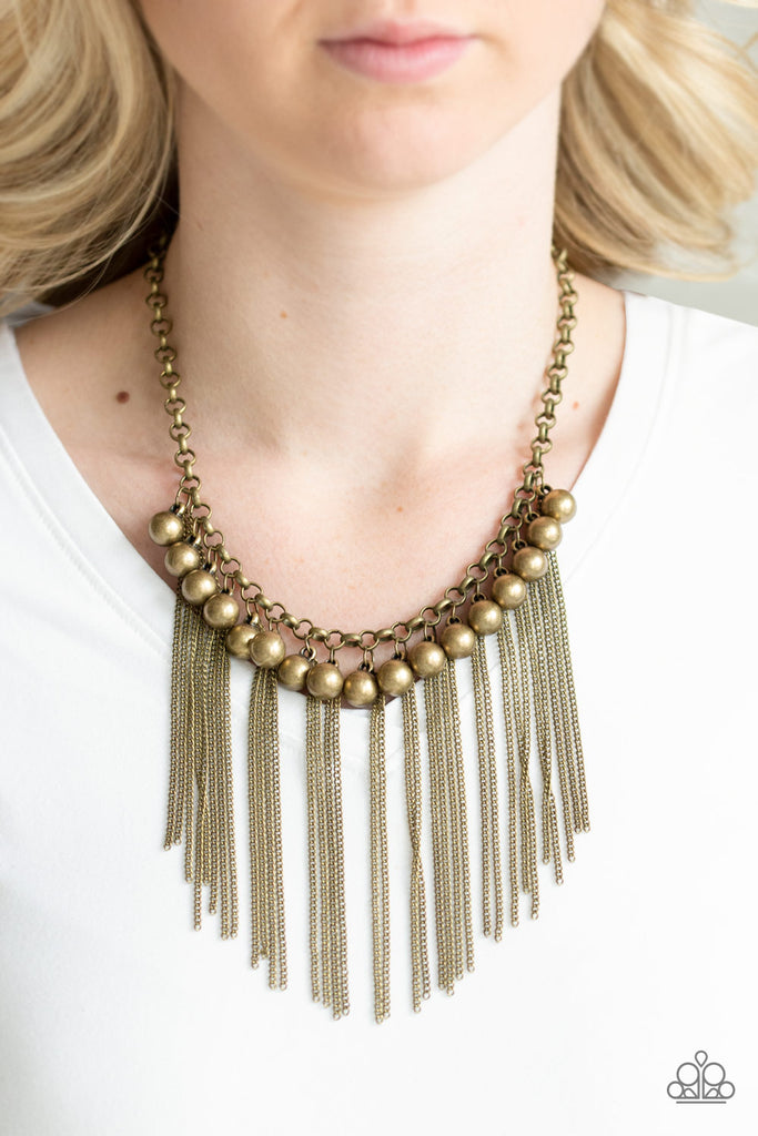 Glistening brass chains stream from the bottom of shimmery brass beads, creating an edgy industrial fringe below the collar. Features an adjustable clasp closure.  Sold as one individual necklace. Includes one pair of matching earrings.