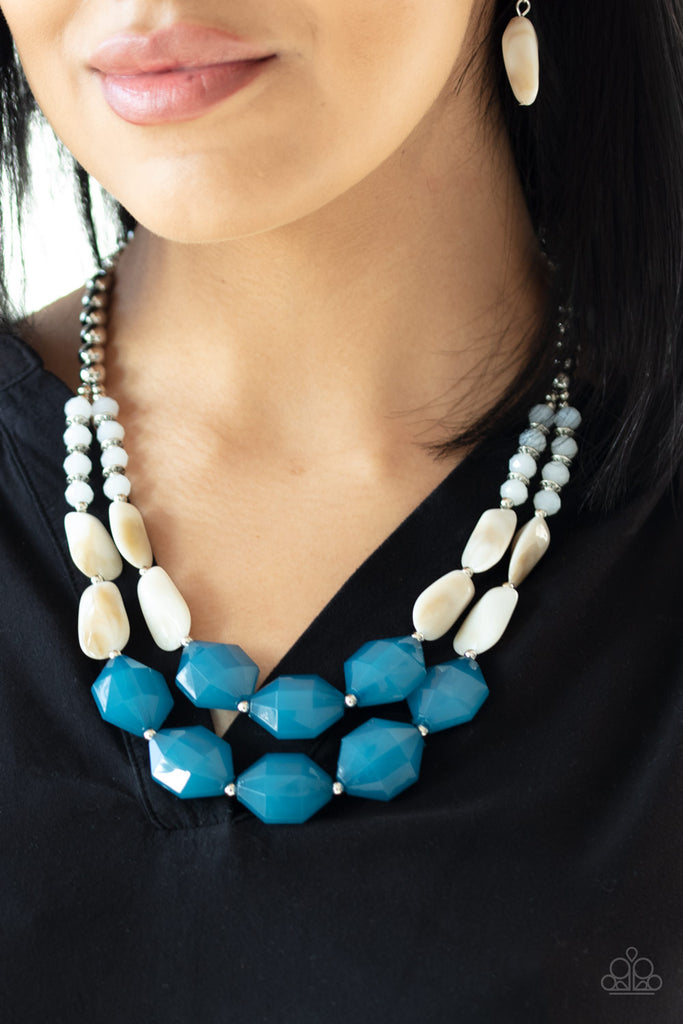 A whimsical collection of silver, opaque crystal-like, cloudy white, and faceted blue beads are threaded along invisible wires, creating statement-making layers below the collar. Features an adjustable clasp closure.  Sold as one individual necklace. Includes one pair of matching earrings.