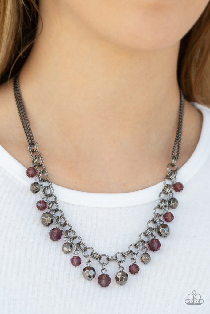 A collection of faceted gunmetal beads and purple crystal-like beads swing from the bottom of a double-link gunmetal chain, creating a blinding fringe below the collar. Features an adjustable clasp closure.  Sold as one individual necklace. Includes one pair of matching earrings.