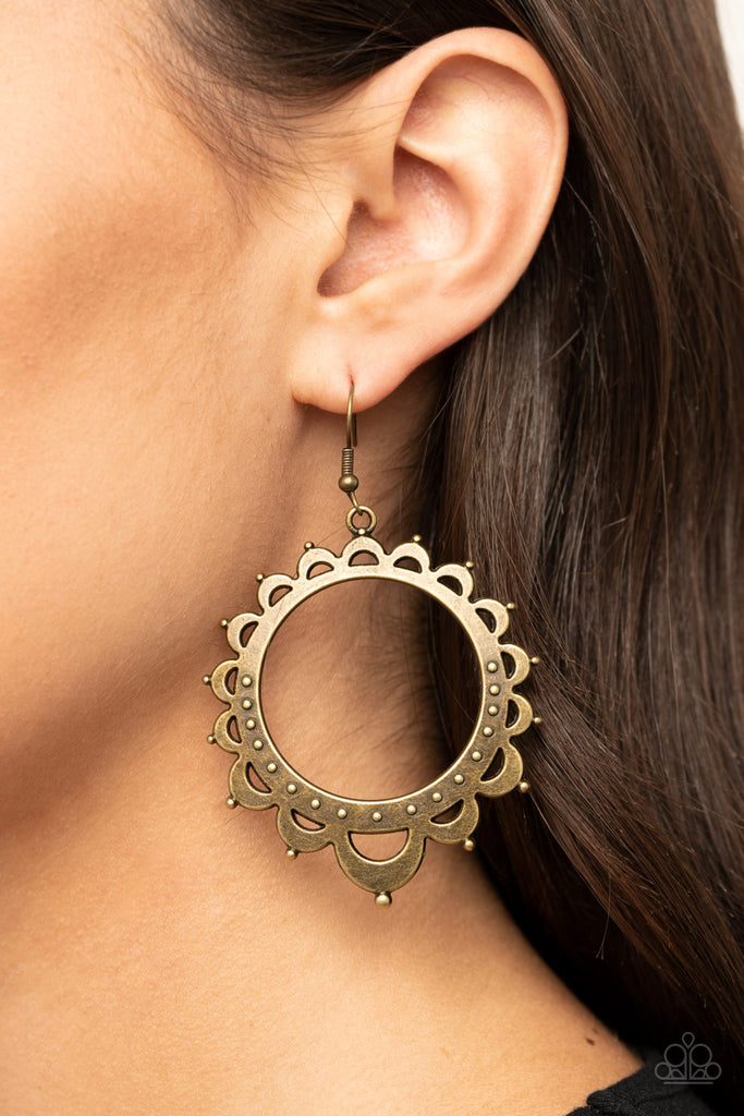 Studded petal-like frames radiate out from an antiqued brass hoop, coalescing into a whimsical sunburst. Earring attaches to a standard fishhook fitting.  Sold as one pair of earrings.