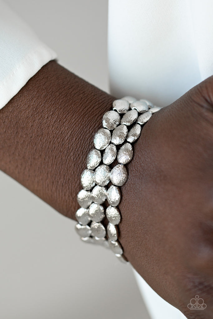 Radiating with shimmery textures, dainty silver beads are threaded along stretchy bands around the wrist for a casually layered look.  Sold as one set of three bracelets.