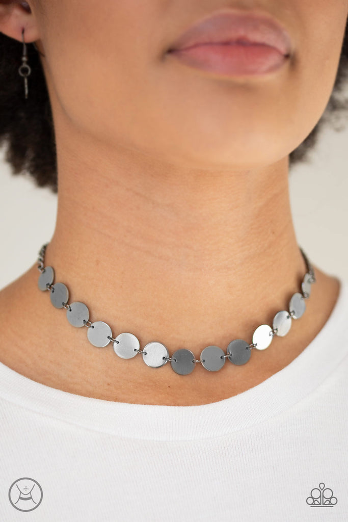 Brushed in a high-sheen finish, shiny gunmetal discs link around the neck for a retro look. Features an adjustable clasp closure.  Sold as one individual choker necklace. Includes one pair of matching earrings.