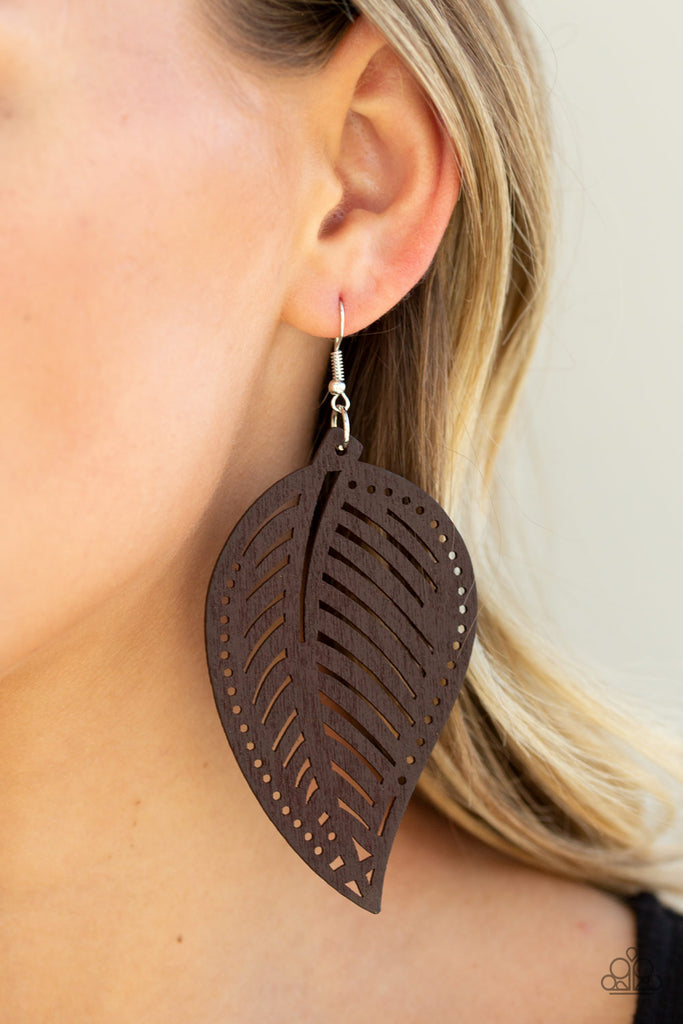 Featuring stenciled detail, a brown wooden leaf swings from the ear for a seasonal flair. Earring attaches to a standard fishhook fitting.  Sold as one pair of earrings.