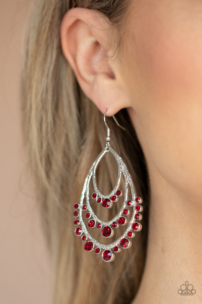 A gorgeous collection of fiery red rhinestones drip from the bottom of a tiered silver frame, coalescing into a dazzling statement piece. Earring attaches to a standard fishhook fitting.  Sold as one pair of earrings.