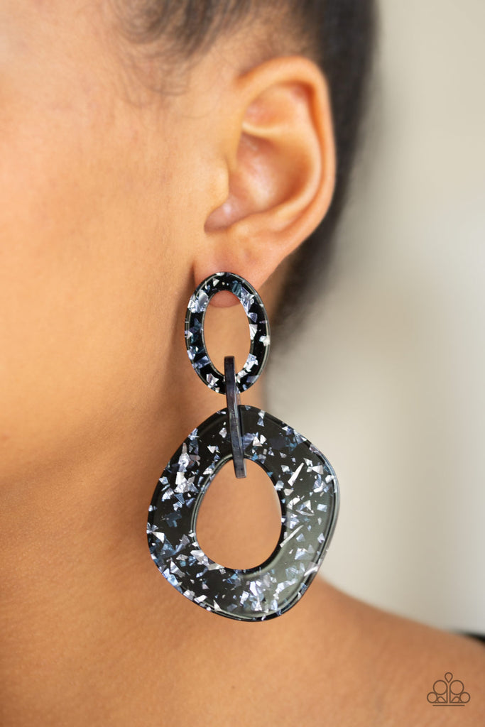 Flecked in metallic shimmer, glittering acrylic frames link into an abstract frame for a retro-radiant look. Earring attaches to a standard post fitting.  Sold as one pair of post earrings.