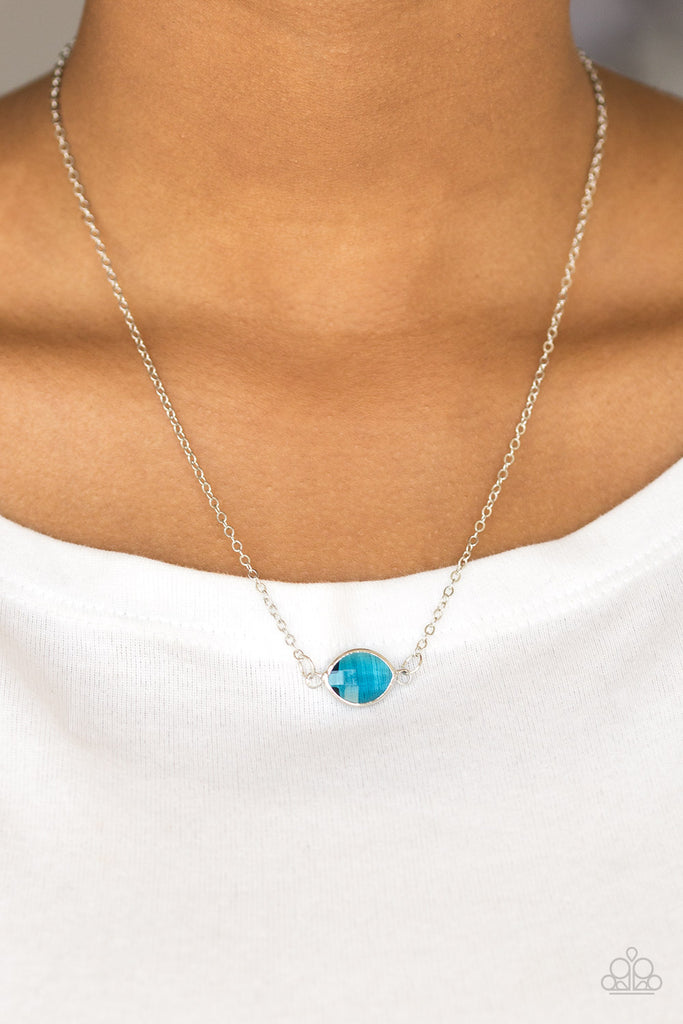 Featuring a regal marquise style cut, a glassy blue gem attaches to two shimmery silver chains, creating a stationary pendant below the collar for a refined look. Features an adjustable clasp closure.  Sold as one individual necklace. Includes one pair of matching earrings.