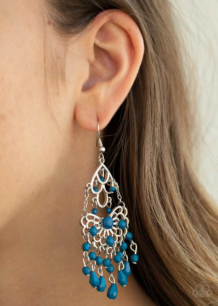 Infused with a dainty collection of Mosaic Blue beads, two frilly silver frames link into a whimsically stacked lure as matching teardrop and round beaded tassels swing from the bottom. Earring attaches to a standard fishhook fitting.  Sold as one pair of earrings.