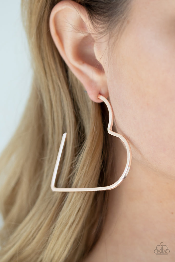 A flat rose gold bar delicately bends into an airy heart frame for a flirtatious finish. Earring attaches to a standard post fitting. Hoop measures approximately 2" in diameter.  Sold as one pair of hoop earrings.