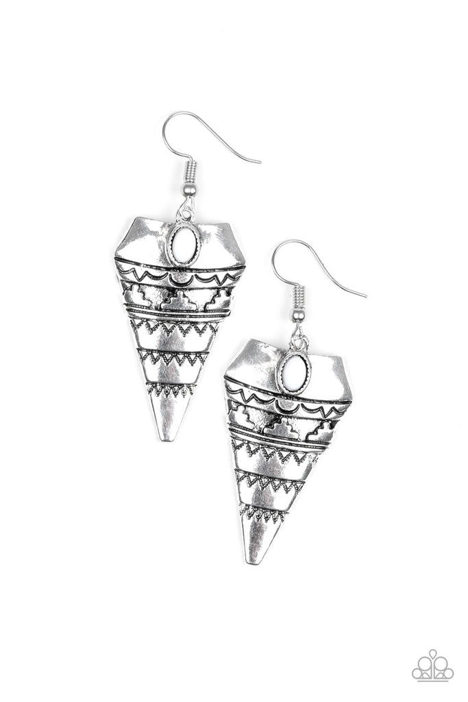 Stamped and embossed in tribal inspired patterns, an antiqued triangular frame swings from the ear. A dainty white bead is pressed into the top of the frame for a refreshing splash of color. Earring attaches to a standard fishhook fitting.  Sold as one pair of earrings.