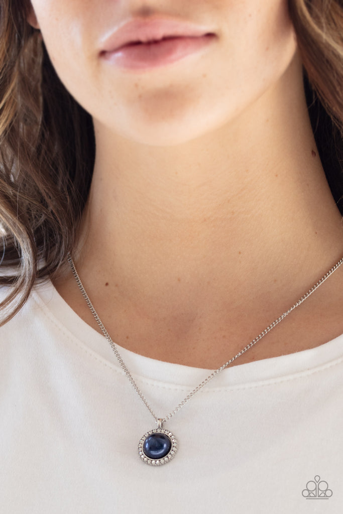 A pearly blue bead is pressed into the center of a ring of white rhinestones, creating a timeless pendant below the collar. Features an adjustable clasp closure.  Sold as one individual necklace. Includes one pair of matching earrings.