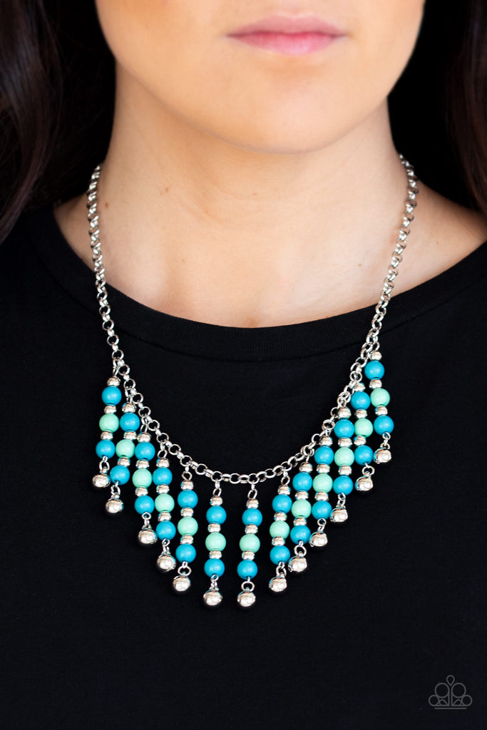 A collection of blue, green, and silver beads are threaded along metallic rods as they swing from the bottom of a shimmery silver chain, creating a flirtatious fringe below the collar. Features an adjustable clasp closure.  Sold as one individual necklace. Includes one pair of matching earrings.