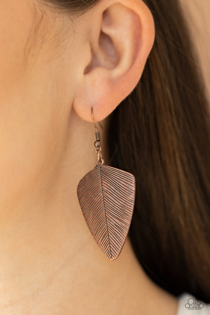Stamped in antiqued details, a dainty copper feather delicately swings from the ear for a rustic look. Earring attaches to a standard fishhook fitting. Sold as one pair of earrings.