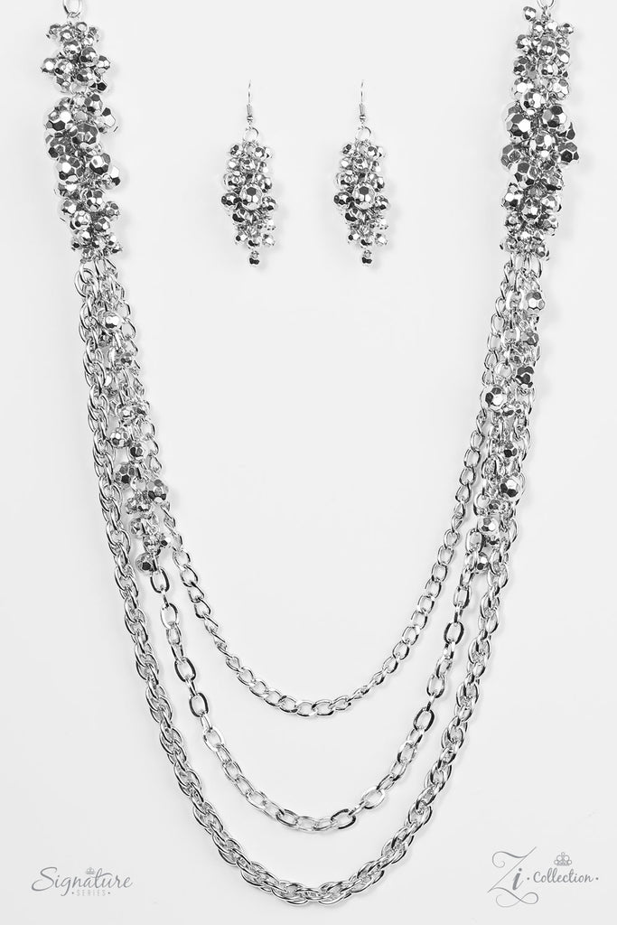 Clusters of faceted silver beading give way to layers of bold silver chain. Varying in size and shimmer, the dramatic silver chains drape across the chest, while sparkly silver beading trickles down the sides of the centermost chain for an edgy finish. Features an adjustable clasp closure.  Named after 2017 Rock the Runway winner, Shelley A.  Sold as one individual necklace. Includes one pair of matching earrings.