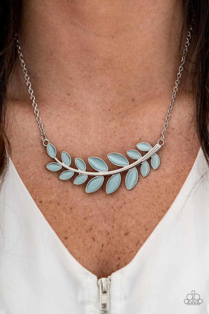 Dotted with tranquil blue cat's eye stones, a leafy silver branch delicately curves below the collar for a whimsical look. Features an adjustable clasp closure.  Sold as one individual necklace. Includes one pair of matching earrings.