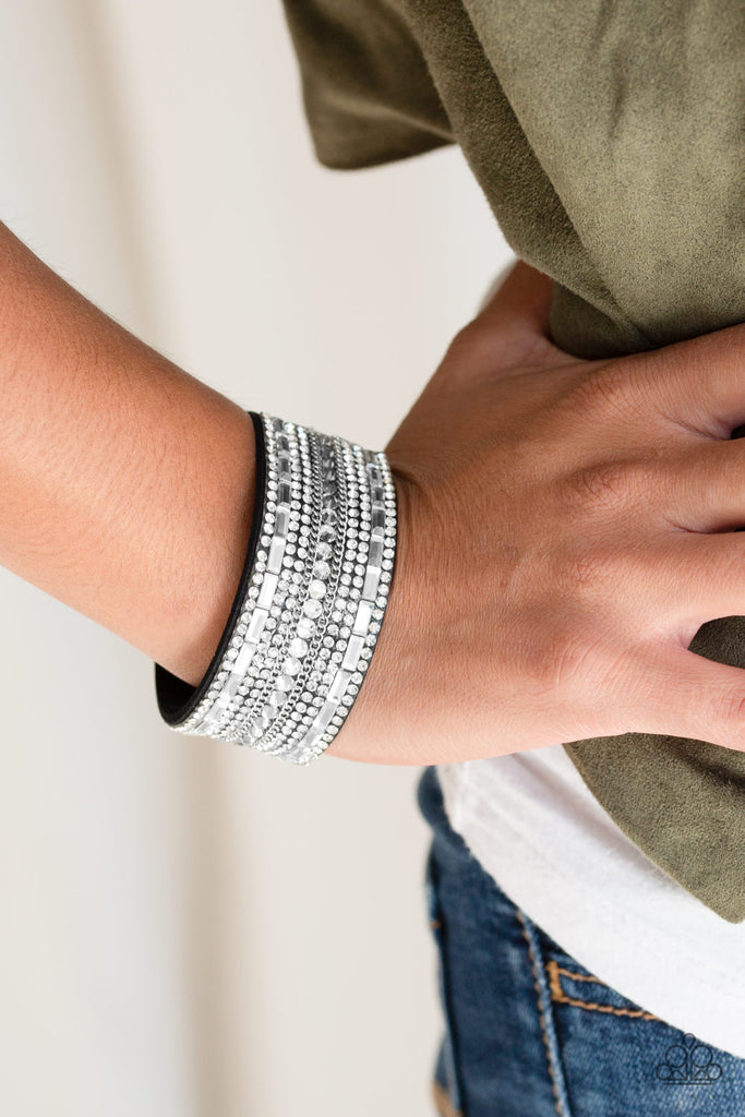 Featuring classic round and edgy emerald style cuts, glittery white rhinestones and glistening silver chains are encrusted along bands of black suede for a sassy look. Features an adjustable snap closure.  Sold as one individual bracelet.